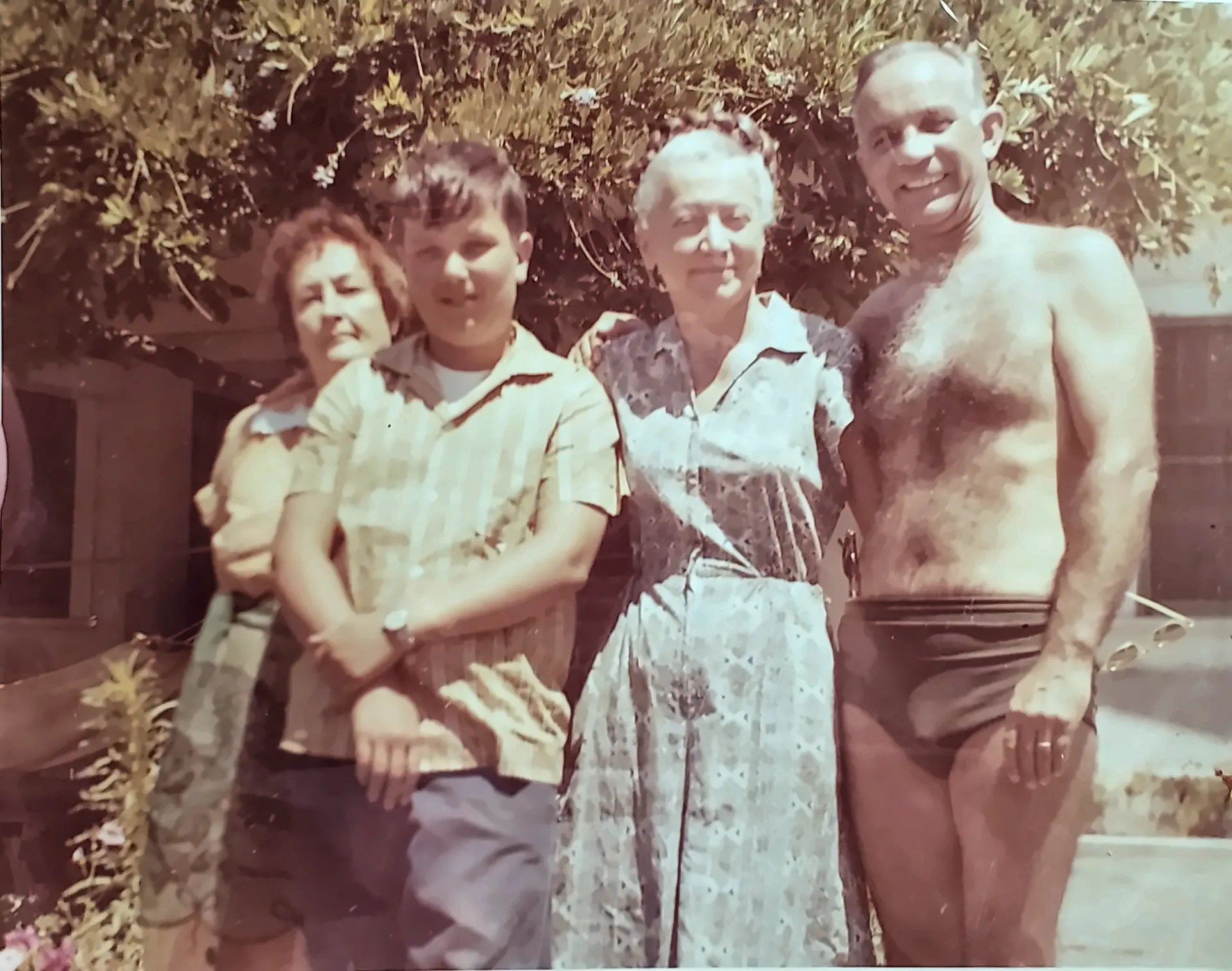 Young Andre with family members outdoors