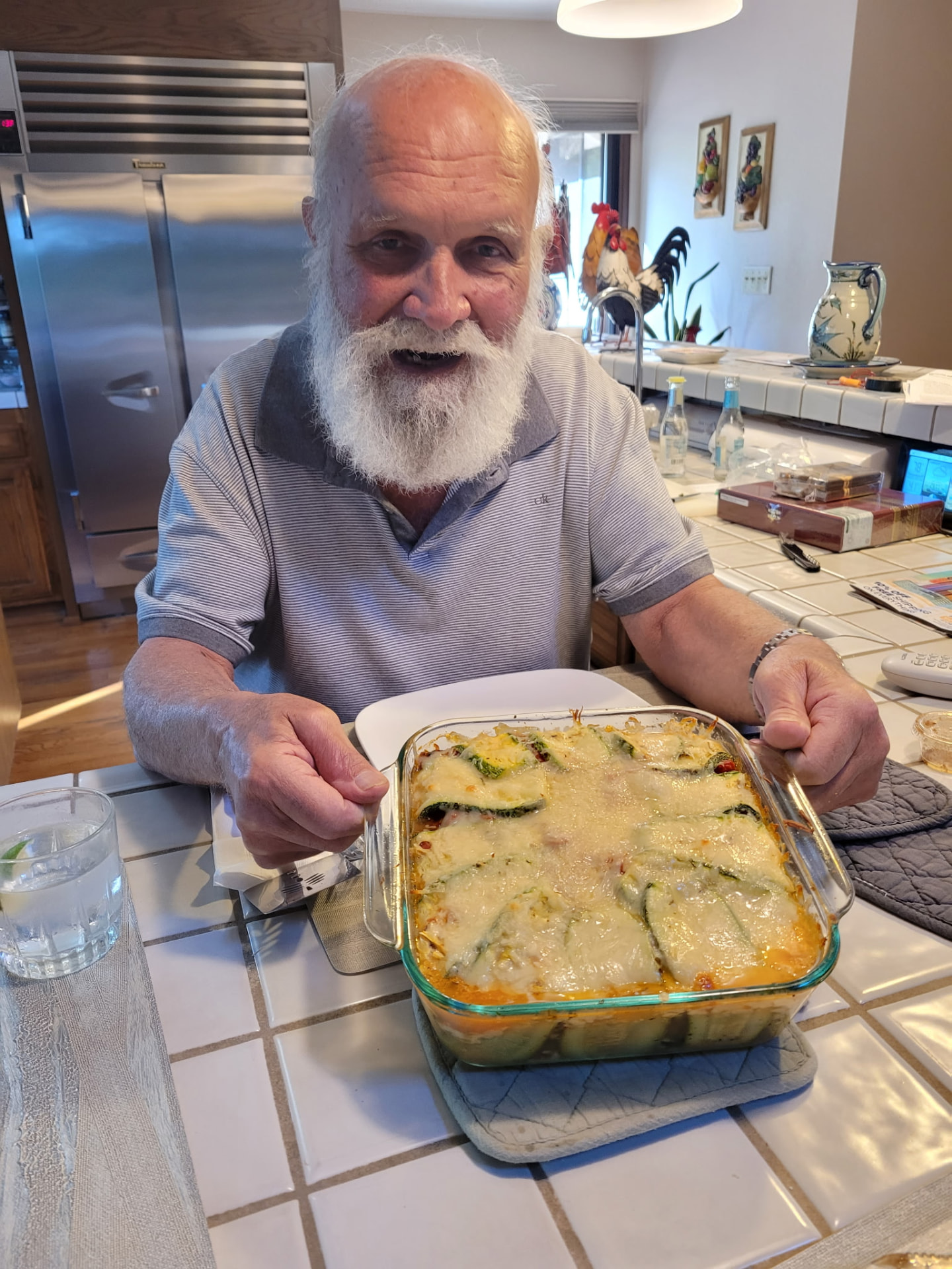 Andre smiling in the kitchen with a freshly prepared dish
