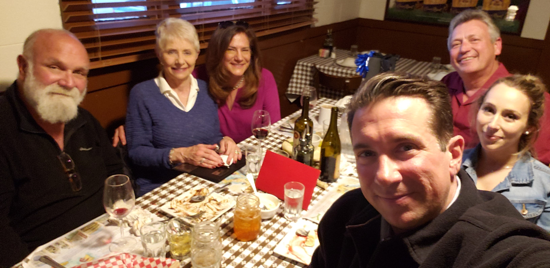 Andre, Gloria and family gathered around a dinner table