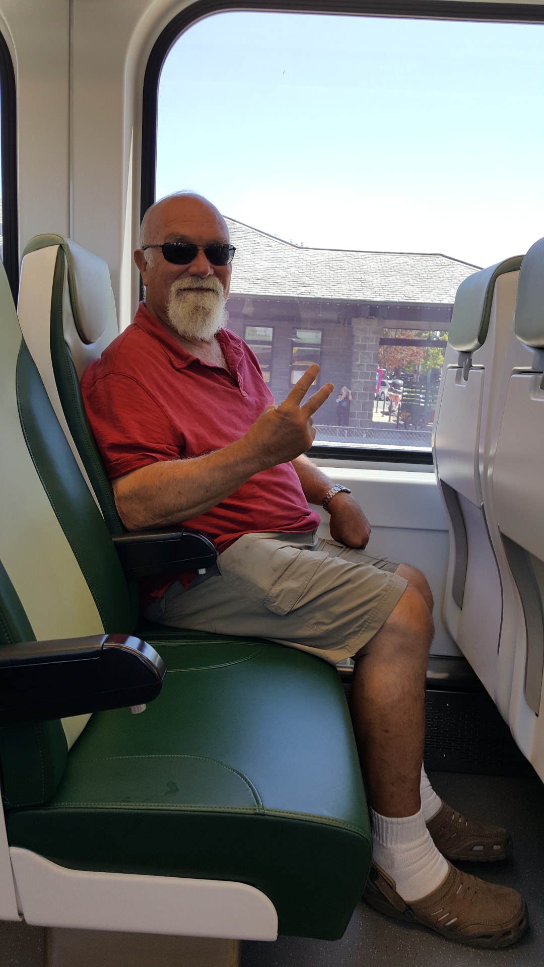 Andre seated beside the window on a train
