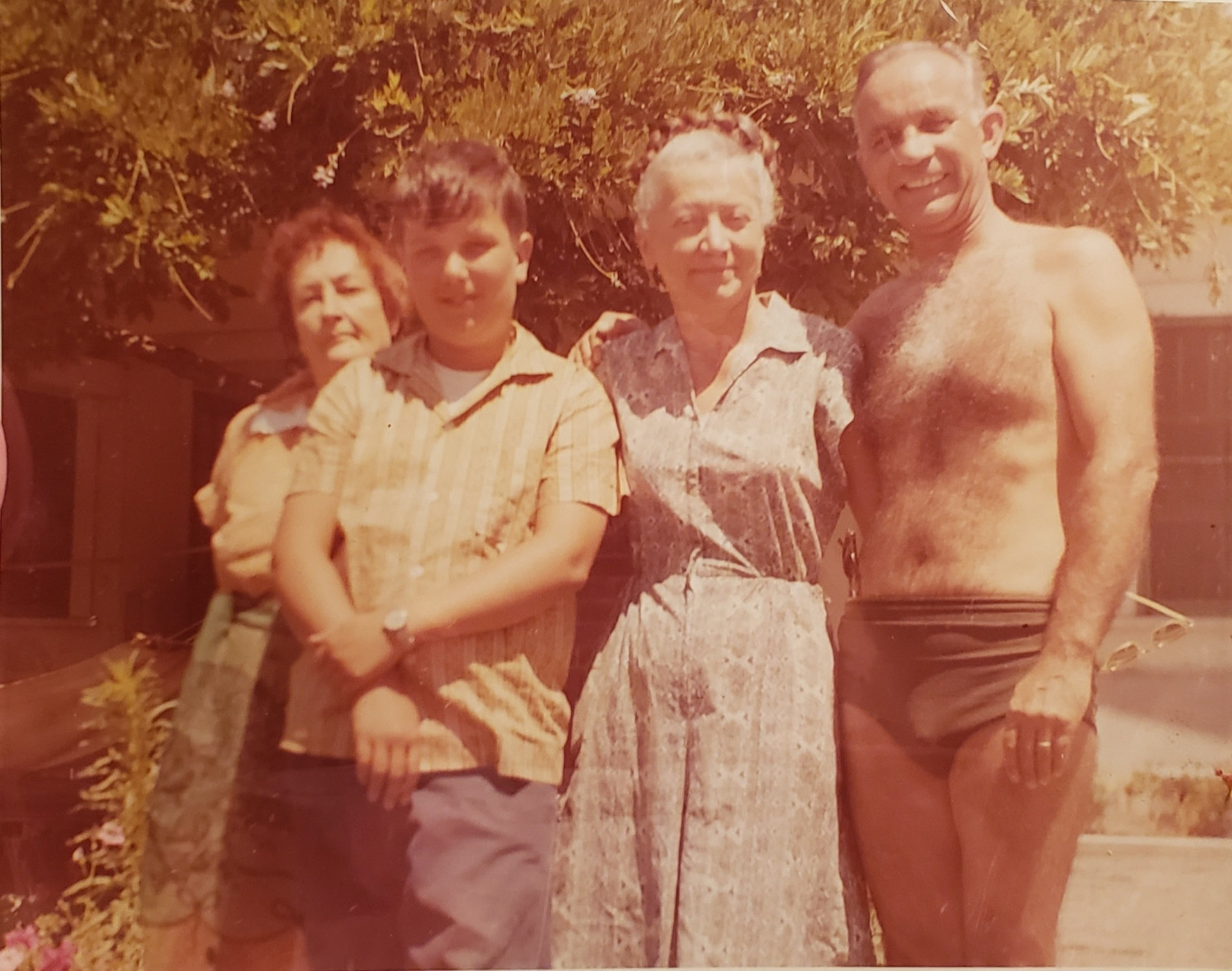 Young Andre with family members outdoors