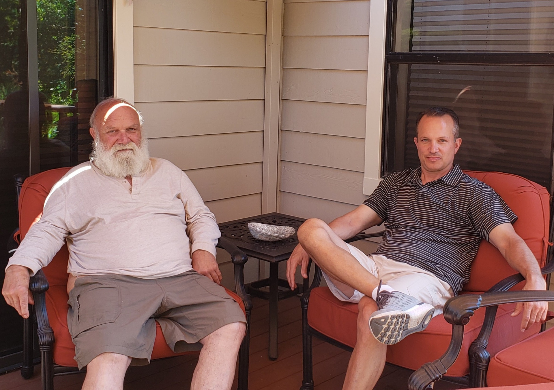 Andre relaxing on the porch with one of his sons
