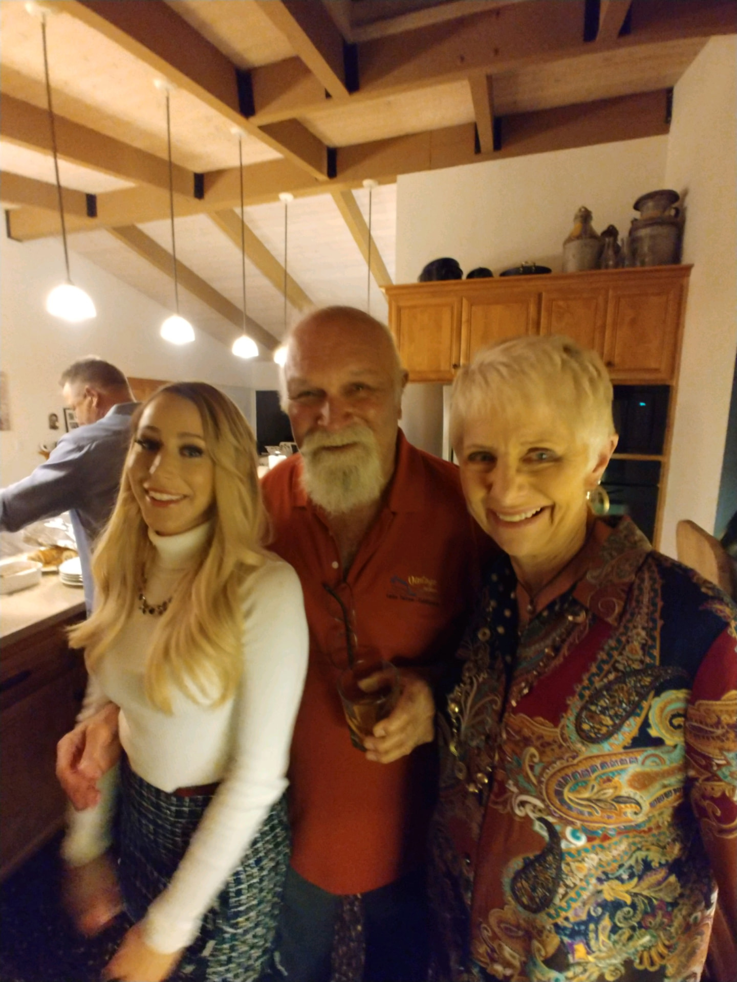 Andre and Gloria at home in the kitchen with a family friend